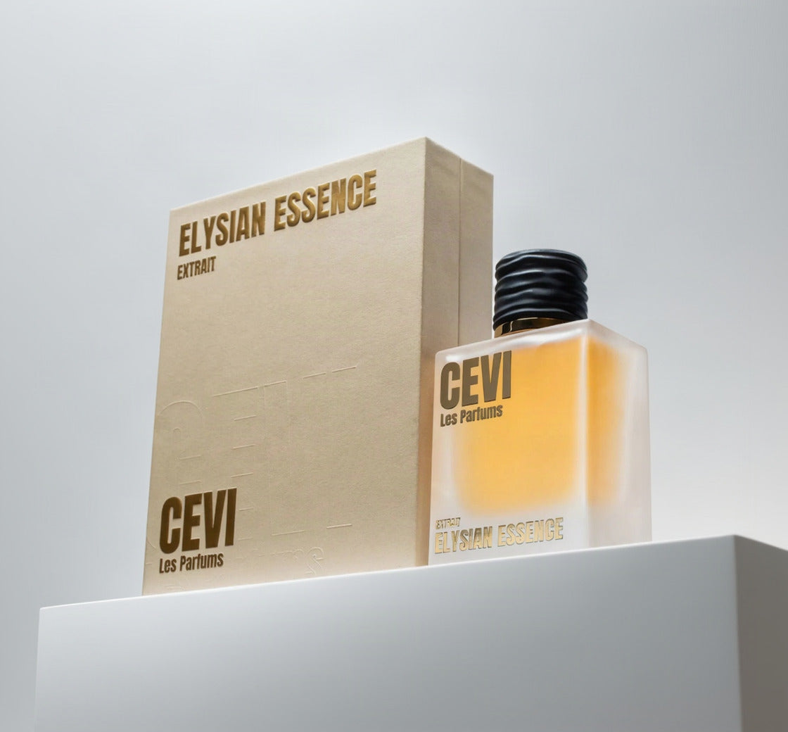 CEVI Les Parfums Elysian Essence Extract perfume bottle with amber liquid and a black cap, shown next to its textured beige packaging box on a white background.