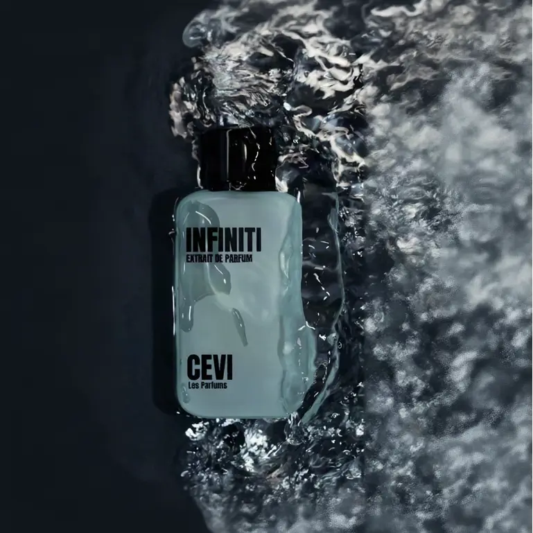 A sleek translucent light blue rectangular perfume bottle with black cap and infiniti extrait de parfum label