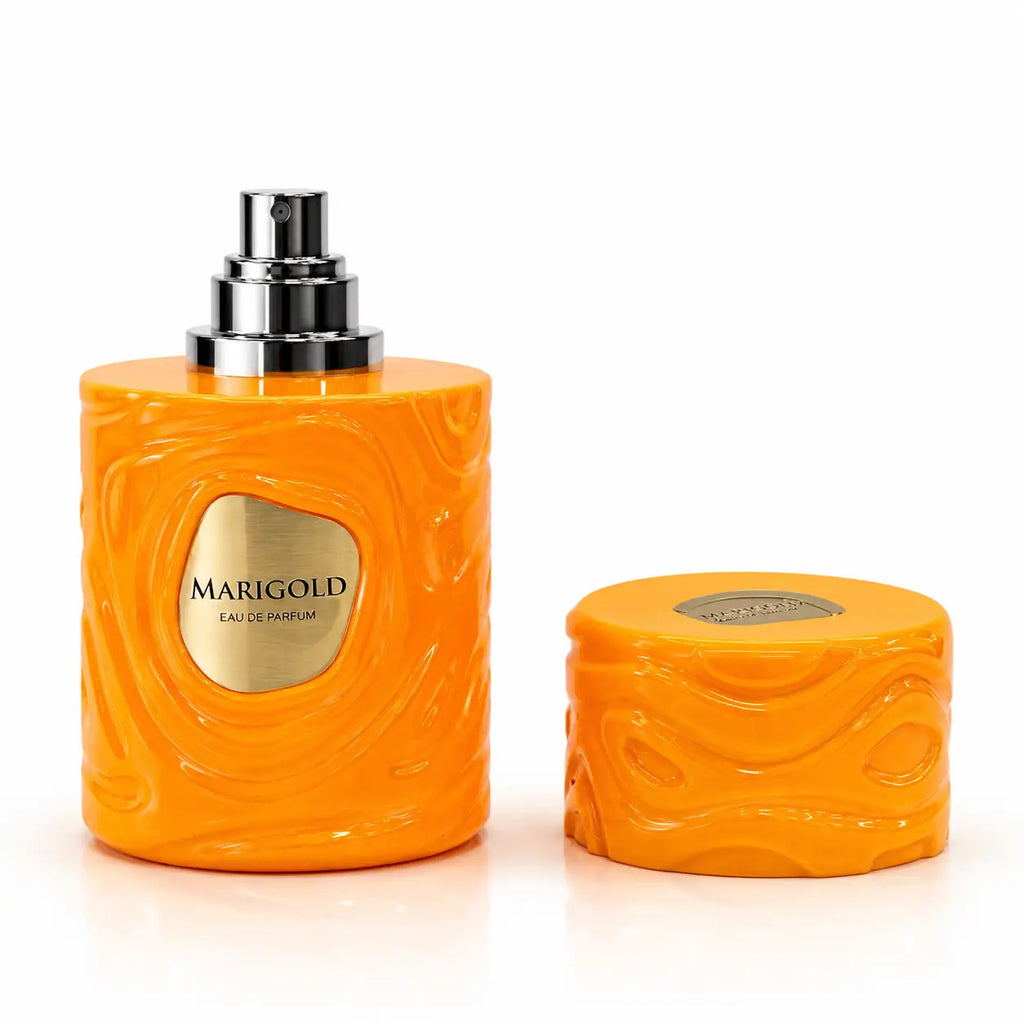 Vibrant orange marigold le bonheur eau de parfum 100ml bottle with textured swirling design and sleek silver spray nozzle