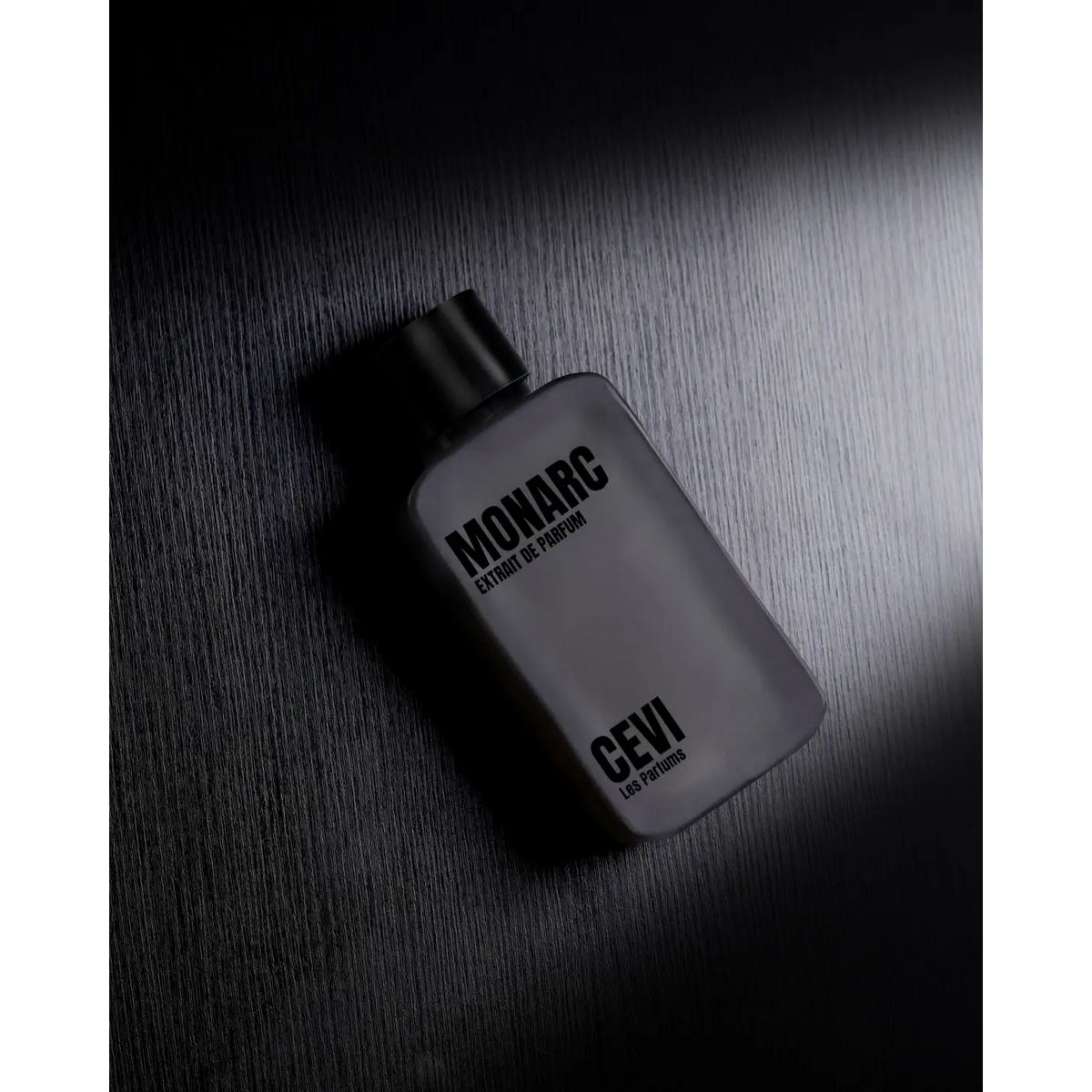 A sleek frosted glass bottle of monarc extract de parfum by cevi 189 parfums with a matte black cap 100ml