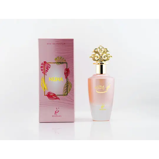Pink gradient glass perfume bottle with gold ornate cap and nuha branding beside matching pink floral box for nuha khadlaj edp 85ml