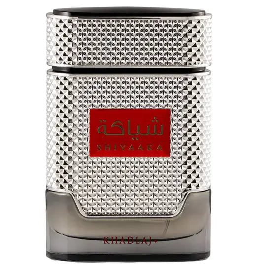 Silver textured perfume bottle with red label featuring shiyaara brand name in arabic and english for shiyaaka silver khadlaj edp 100ml